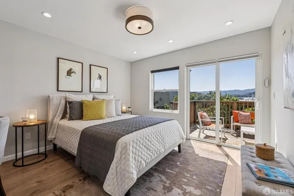 a bedroom with a bed and a large window