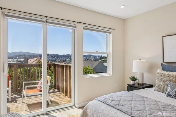 a bedroom with a large window and a bed