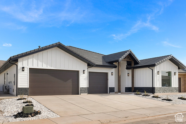 3145 Snow Cyn Road Hurricane, UT 84737 - Photo 3 of 38 Modern farmhouse style home featuring stone siding, a garage, board and batten siding, and driveway