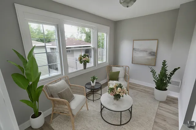 a dining room with furniture and a potted plant