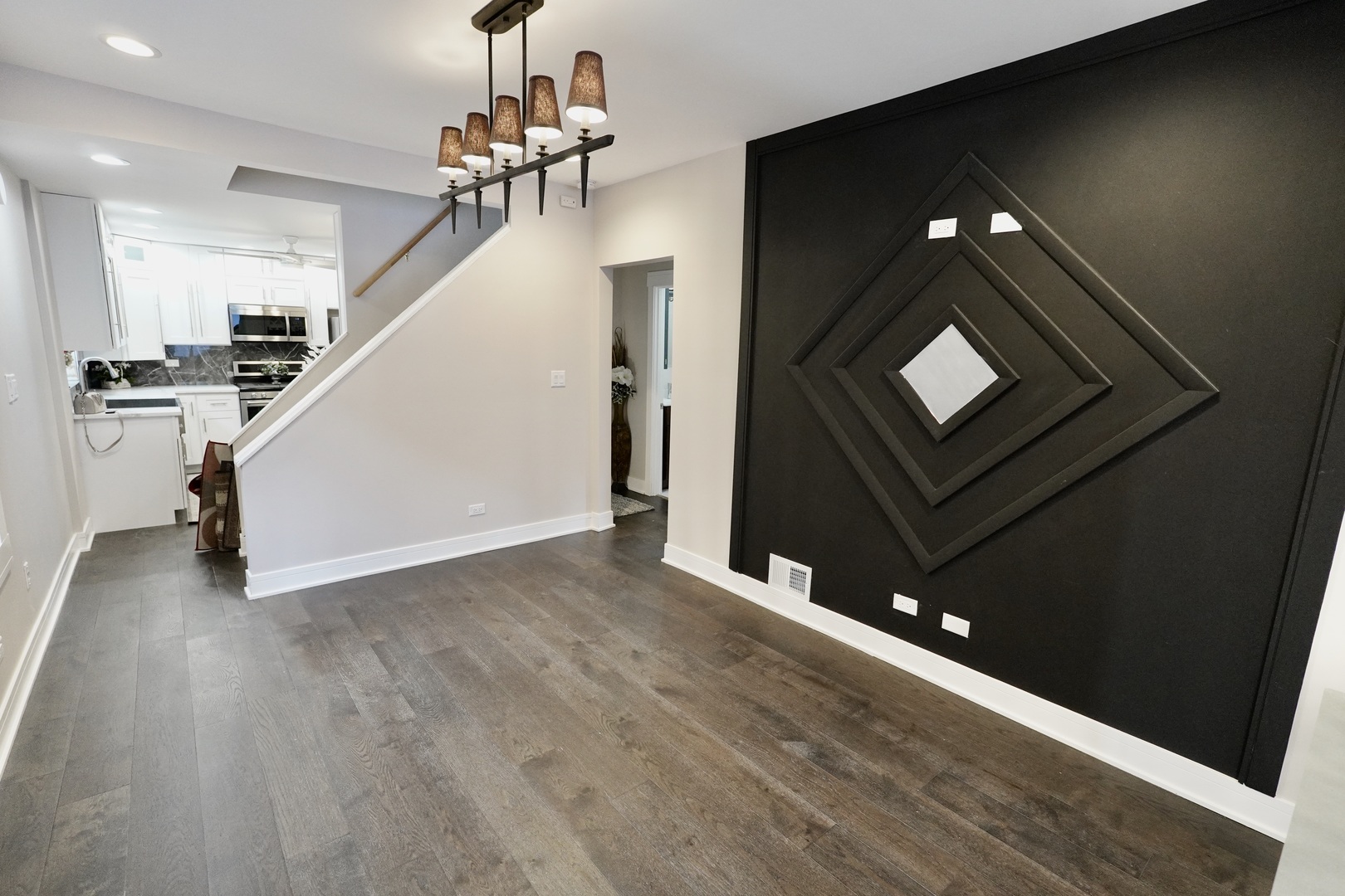 8734 South Honore Street Chicago, IL 60620 - Photo 6 of 33 a view of a hallway with wooden floor and staircase