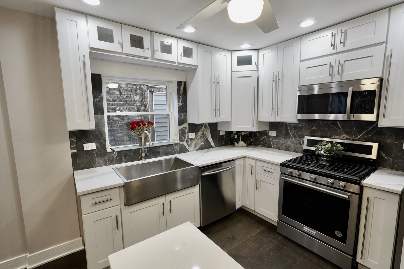 8734 South Honore Street Chicago, IL 60620 - Photo 8 of 33 a kitchen with stainless steel appliances a stove sink microwave and cabinets