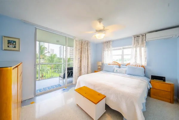 a bedroom with a bed and a large window with outer view