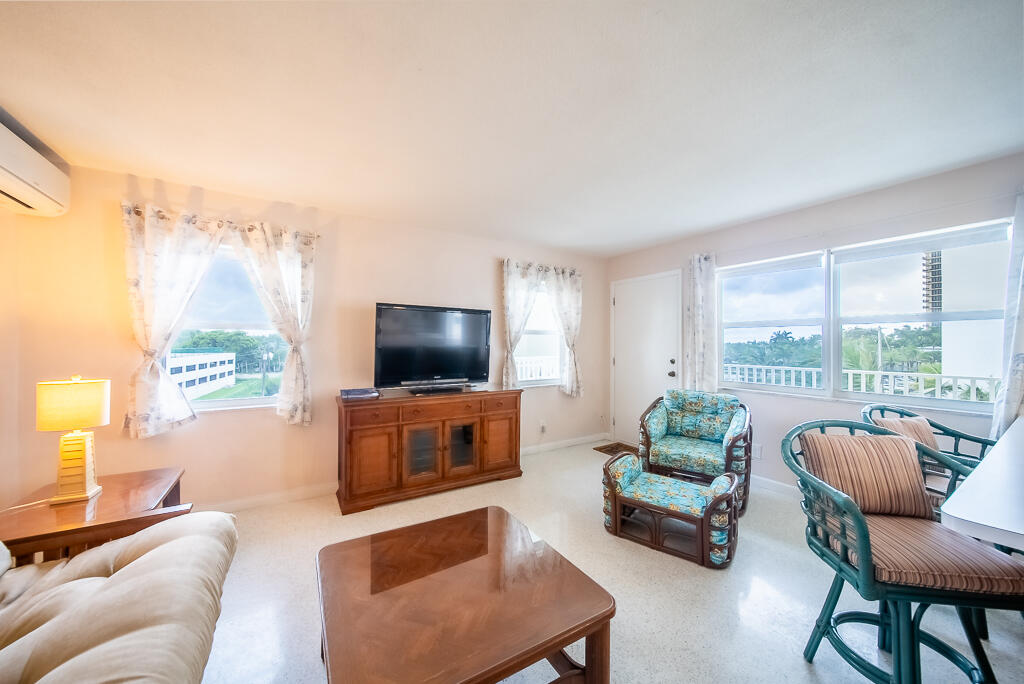3600 North Ocean Drive, Unit 421 Singer Island, FL 33404 - Photo 7 of 31 a living room with furniture a flat screen tv and a large window