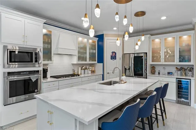 a kitchen with a stove a sink and a refrigerator