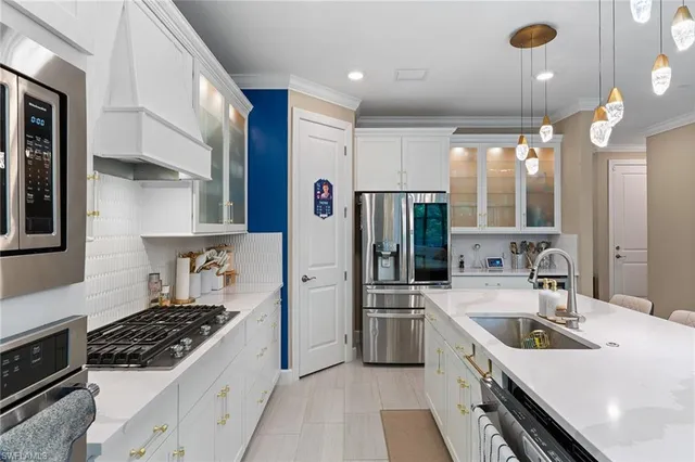 a kitchen with a sink stove and refrigerator