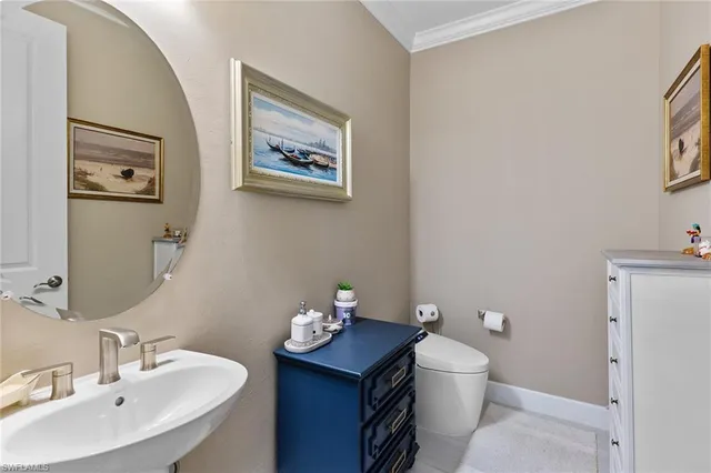 a bathroom with a toilet a sink and mirror