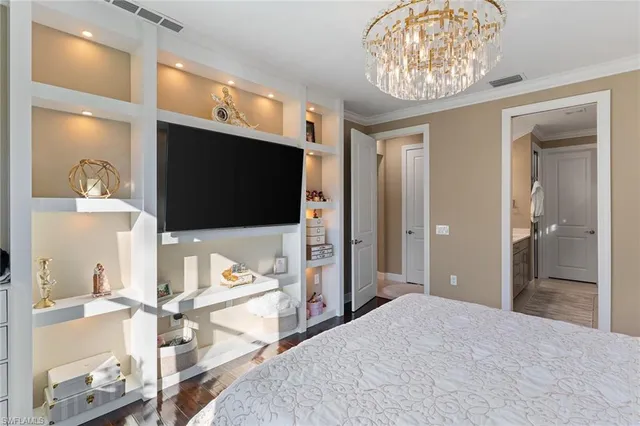 a bedroom with a bed and a flat screen tv in it