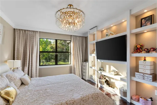 a bedroom with furniture and a flat screen tv