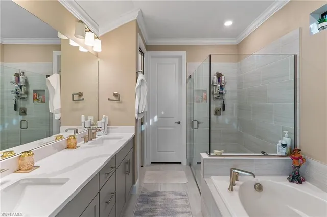 a bathroom with a granite countertop tub sink shower and mirror