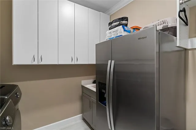 a kitchen with a refrigerator and cabinets