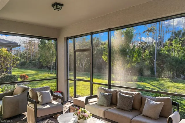 a living room with furniture and a floor to ceiling window