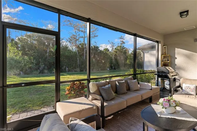 a balcony with furniture and a floor to ceiling window