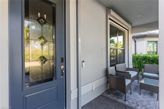 a room that has a glass door and furniture