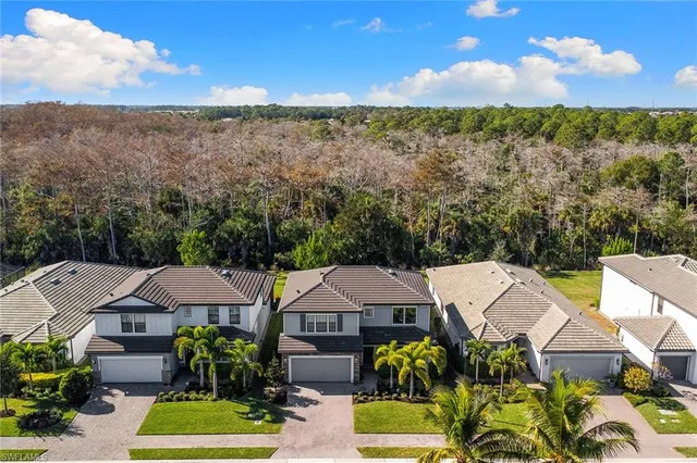 a view of a garden with a house in the background