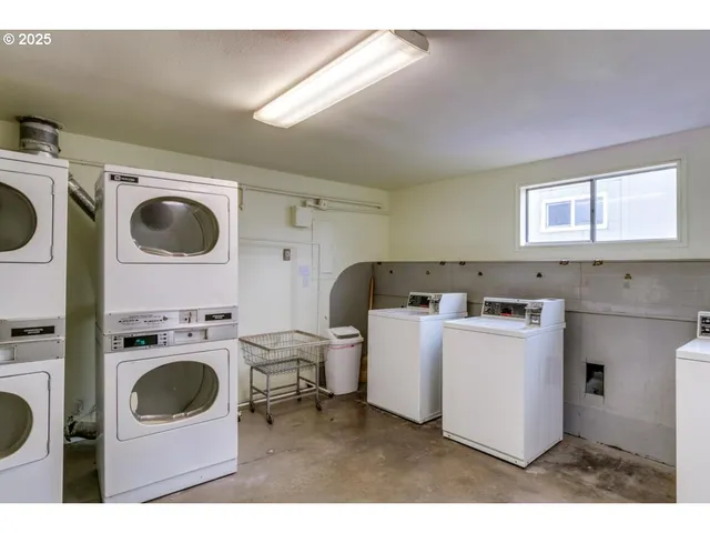 a room with pool table and windows