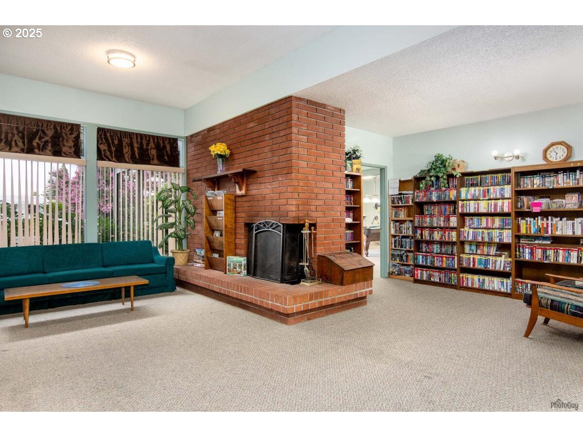 2150 Laura Street, Unit 83 Springfield, OR 97477 - Photo 32 of 40 a living room with furniture gym equipment and a fireplace