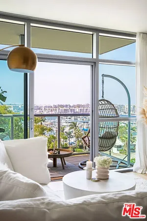a view of a balcony with floor to ceiling windows yard and ocean view