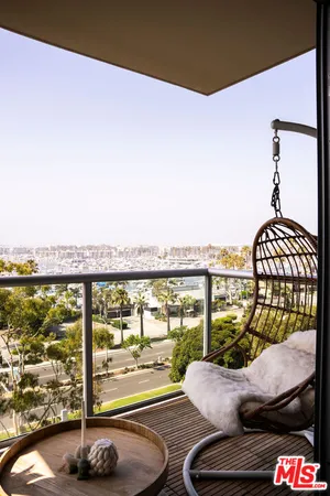a living room with a couch and a potted plant
