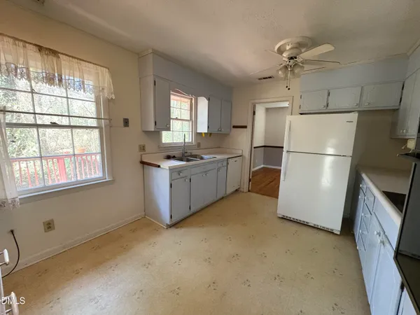a kitchen with stainless steel appliances a refrigerator and a stove top oven