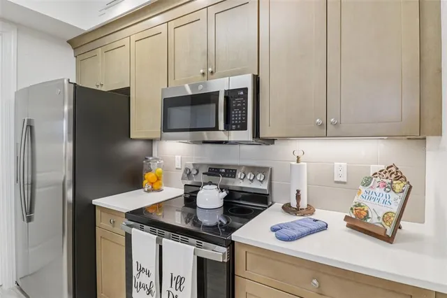 a kitchen with stainless steel appliances kitchen island granite countertop a sink and cabinets