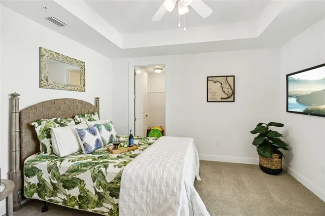 a bedroom with a bed and ceiling fan