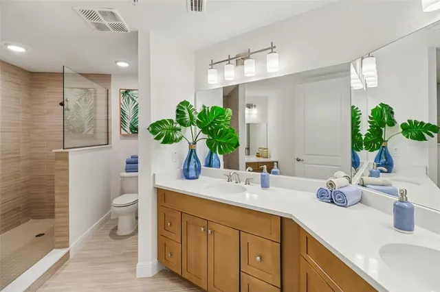 a bathroom with a toilet and a shower