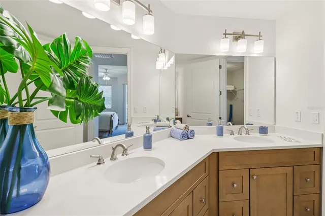 a bedroom with a bed a chandelier and a window