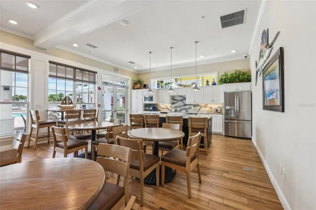 a kitchen with kitchen island a stove a sink and a refrigerator