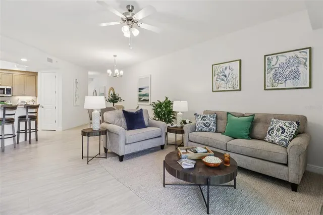 a dining room with furniture a chandelier and wooden floor