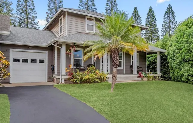 a front view of a house with garden and porch