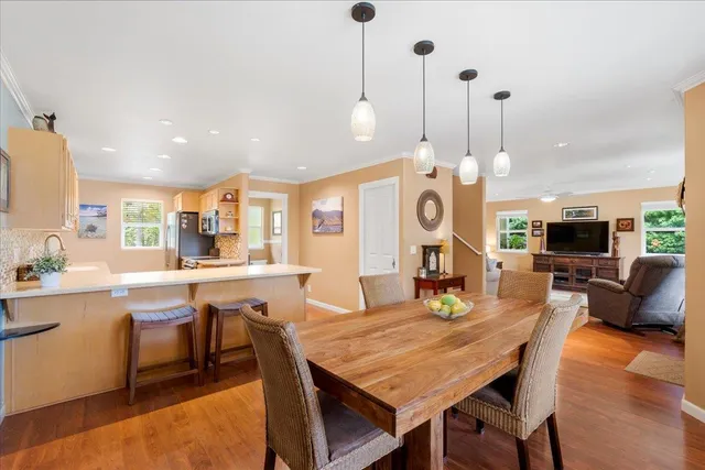 a view of a dining room with furniture and wooden floor