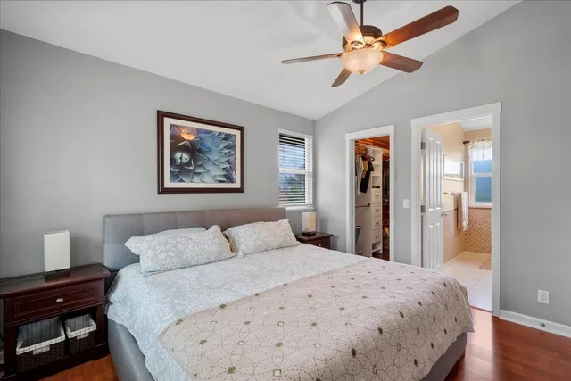 a bathroom with a sink a toilet a mirror and shower