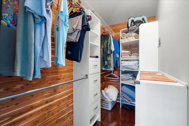 a bedroom with a bed and a flat tv screen on the dresser