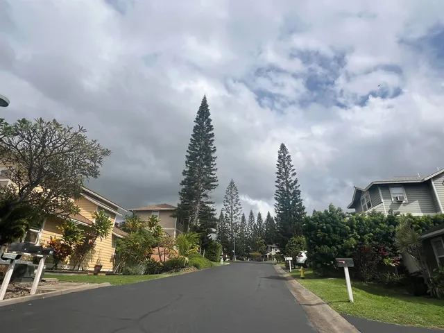 a backyard of a house with wooden floor and outdoor seating