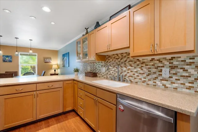 a kitchen with a sink a stove top oven and cabinets