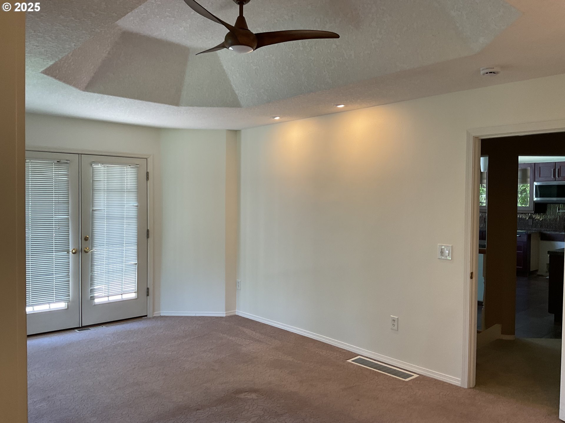 17413 Wake Robin Circle Oregon City, OR 97045 - Photo 12 of 27 an empty room with closet and a chandelier fan