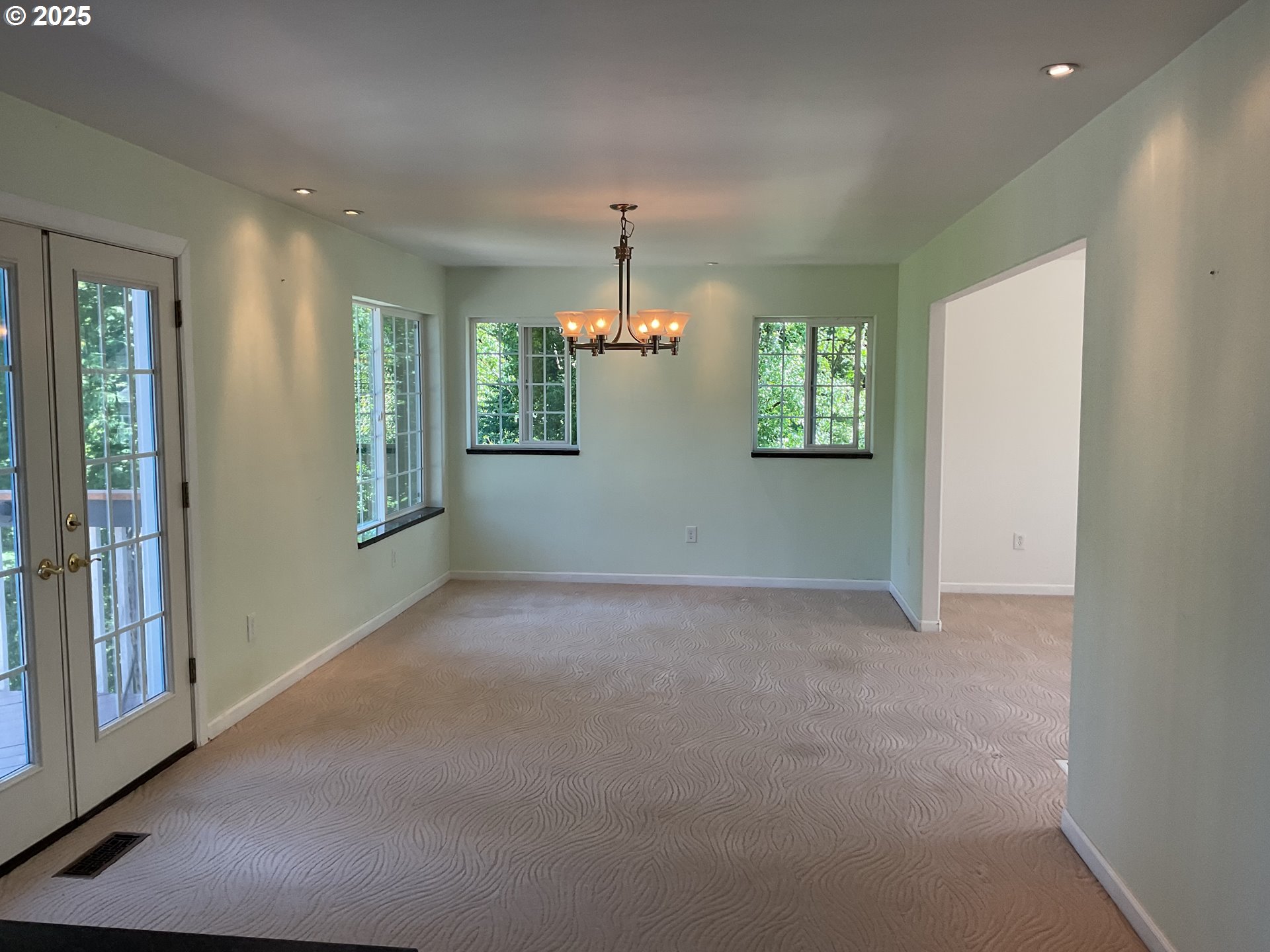 17413 Wake Robin Circle Oregon City, OR 97045 - Photo 8 of 27 an empty room with windows and chandelier