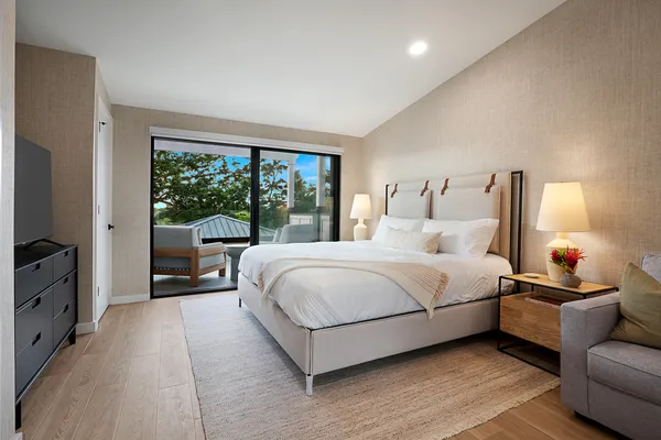 a bedroom with a bed and a large window