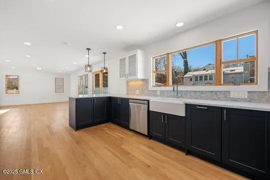 a kitchen with granite countertop a refrigerator and a stove top oven