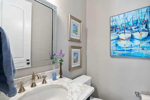 a bathroom with a granite countertop sink toilet a large mirror a shower and vanity