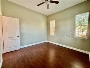 wooden floor in an empty room with a window