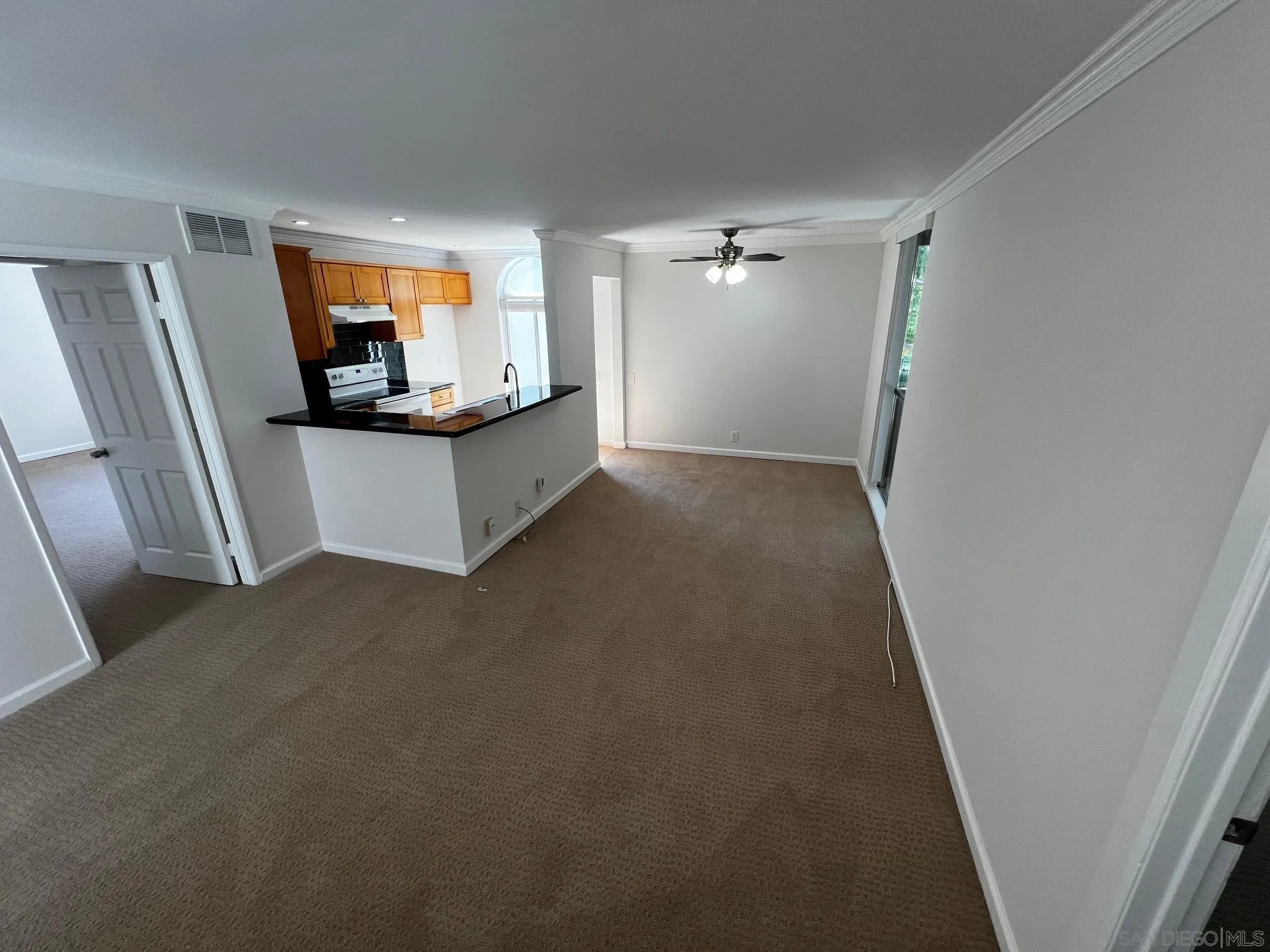 4881 Collwood Boulevard, Unit B San Diego, CA 92115 - Photo 3 of 17 a view of a living room with a flat tv screen and a dresser