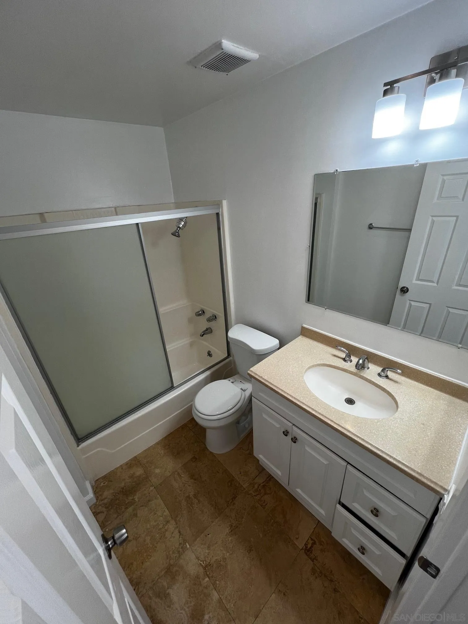 4881 Collwood Boulevard, Unit B San Diego, CA 92115 - Photo 7 of 17 a bathroom with a toilet sink and mirror