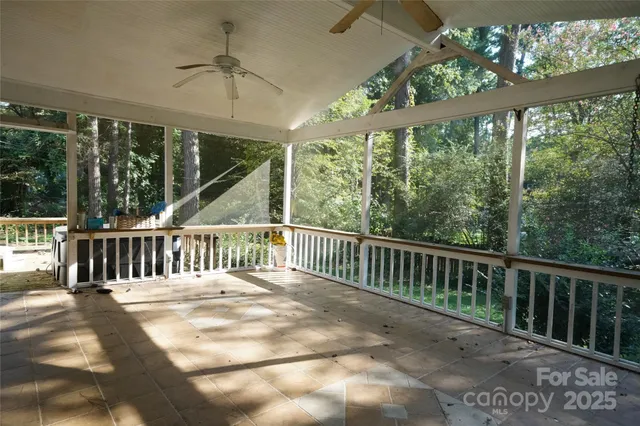a view of a wooden deck with a yard