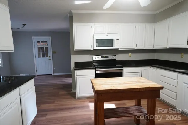 a kitchen with stainless steel appliances a white stove top oven and a refrigerator