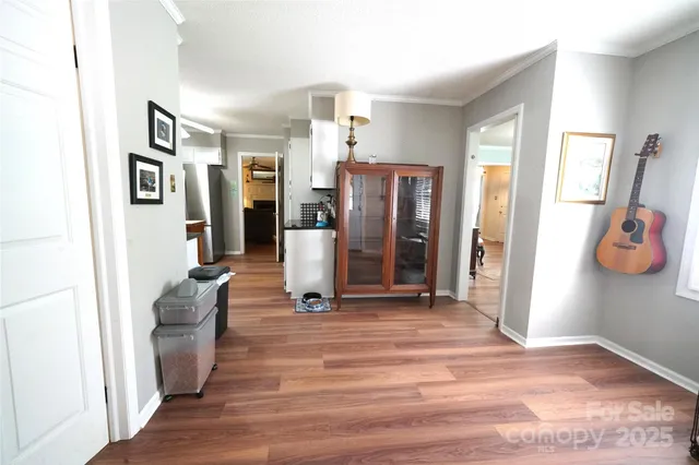 a view of a livingroom with furniture and an empty room