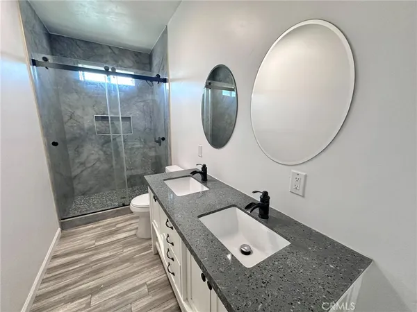 a bathroom with a sink a mirror and a shower