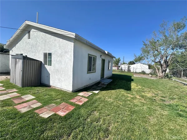 a backyard of a house with yard and garage