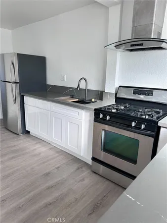 a kitchen with a stove and a refrigerator